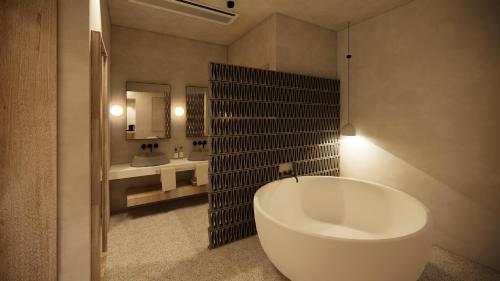 a bathroom with a large tub and a sink at La Gaia - Adult Only in Alanya