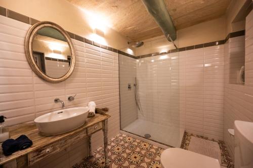 a bathroom with a sink and a shower with a mirror at Arcanum apartment 1 very close to seafront bus station and ferry to Valletta in Senglea