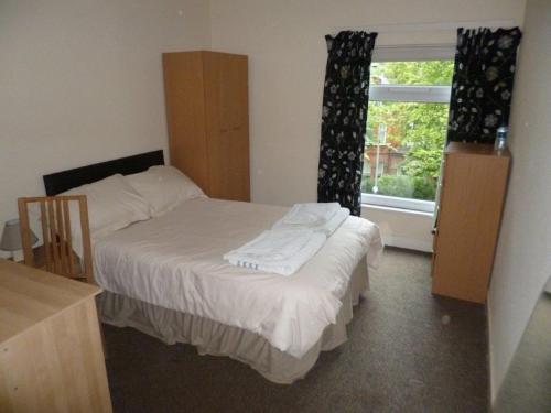 a small bedroom with a bed and a window at The Townhouse in Belfast