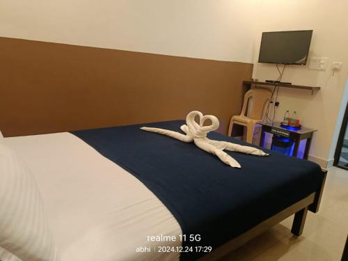 a stuffed animal is sitting on top of a bed at Thiru Pavilion Retreat in Mahabalipuram