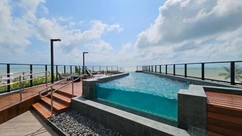 basen z oceanem w tle w obiekcie Loft com hidromassagem frente mar e pé na areia w mieście João Pessoa