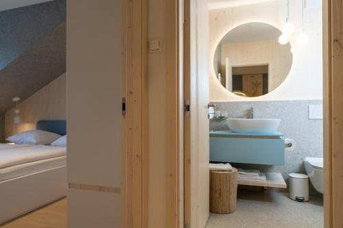 a bathroom with a sink and a mirror at TD Bohinj Apartments in Bohinj