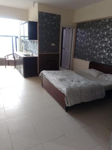 a bedroom with a bed and a sink in it at Kashmir Continental Hotel Murree in Murree
