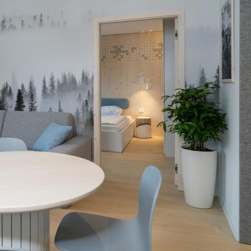 a living room with a couch and a table at TD Bohinj Apartments in Bohinj