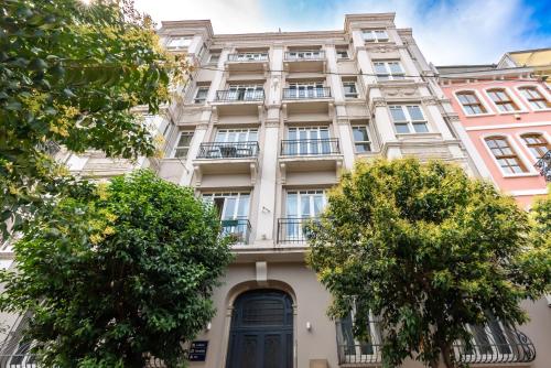 a large white building with trees in front of it at NOA - Lüleci Hendek 54 in Istanbul