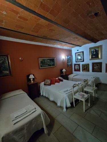 a bedroom with two beds and two chairs in it at La Crota in Asti