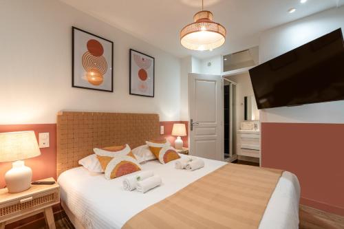 une chambre avec un grand lit blanc avec des oreillers dans l'établissement NEW - Designer Flat for 4 pp, à Paris