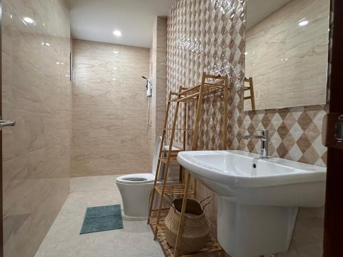 a bathroom with a white sink and a toilet at Luna villa Chaweng Samui in Nathon Bay