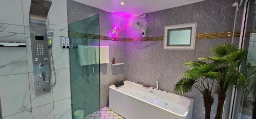 a bathroom with a sink and a shower with purple lights at Prestige Pool Villa by Karon Homes in Karon Beach
