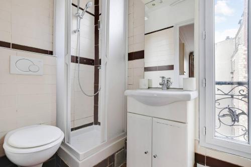 une salle de bain avec toilettes et lavabo dans l'établissement Tour Eiffel - Saint Dominique - Invalides, à Paris