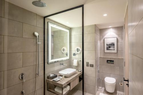 a bathroom with a sink and a mirror at Radisson Resort Khopoli in Khopoli