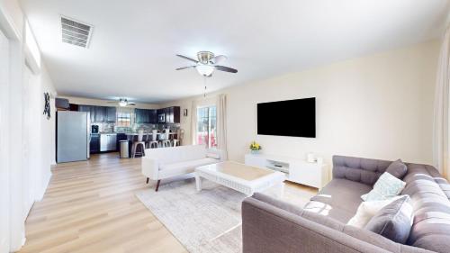 a living room with a couch and a tv at West Atlantic City Bayview House in Pleasantville