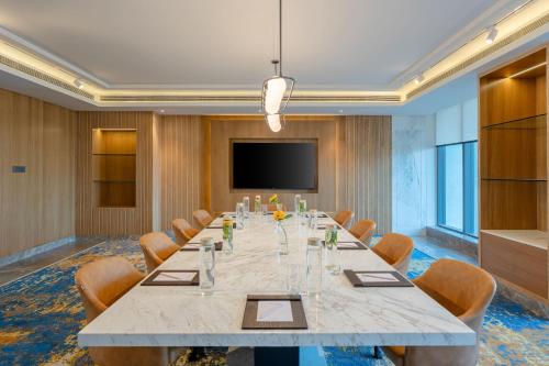 a large conference room with a large table and chairs at Radisson Resort Khopoli in Khopoli