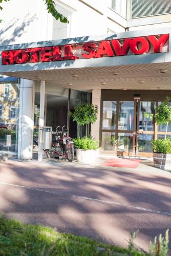 a restaurant with a sign on the front of a building at Hotel Savoy in Mariehamn