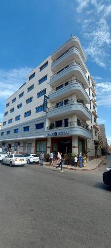 a large white building with cars parked in front of it at MEDINA ORAN in Oran