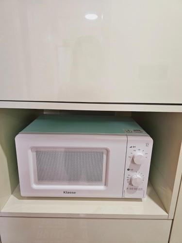 a microwave sitting on a shelf in a drawer at Incheon City Hall Station Full Option Lovely House in Incheon