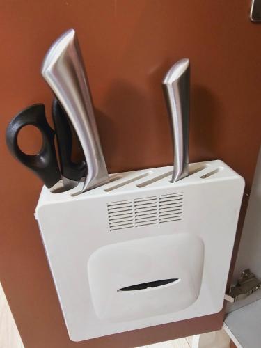 a pair of scissors sitting on top of a toaster at Incheon City Hall Station Full Option Lovely House in Incheon