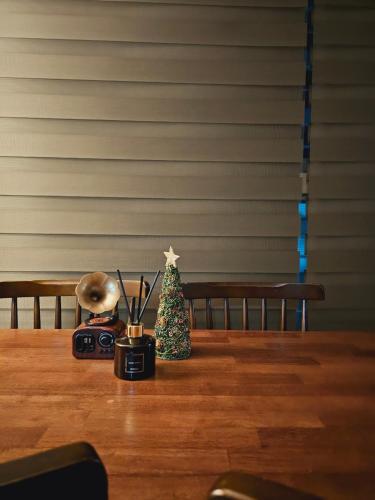 a table with a small christmas tree and a camera at Incheon City Hall Station Full Option Lovely House in Incheon