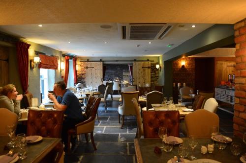 a man sitting at a table in a restaurant at The Inn At Grasmere in Grasmere
