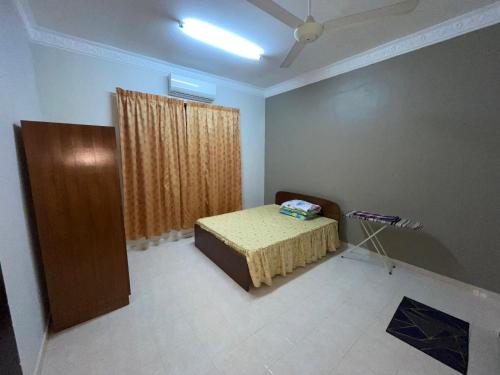 Postel nebo postele na pokoji v ubytování Homestay Bukit Durian