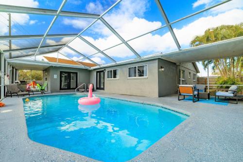 an indoor swimming pool with a glass roof at Beach Villa Private pool fire pit 6mi to beach in Pinellas Park