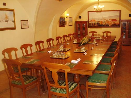 a large wooden table with chairs and a long table at Hotel Wollner in Sopron