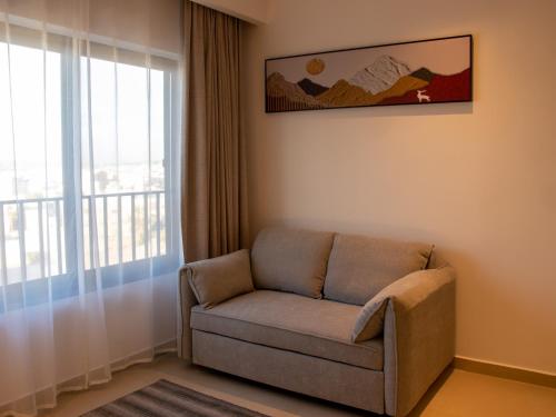 a living room with a couch and a window at Coral Beach Hotel & Spa in Aqaba