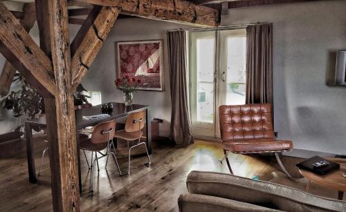 a living room with a desk and a chair at Texel Suites in Oudeschild