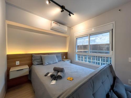 a bedroom with a bed with a camera on it at Vila Mariana - Conforto e Praticidade in Sao Paulo