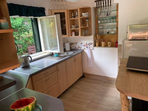 a small kitchen with a sink and a window at Chata na Bunči in Roštín