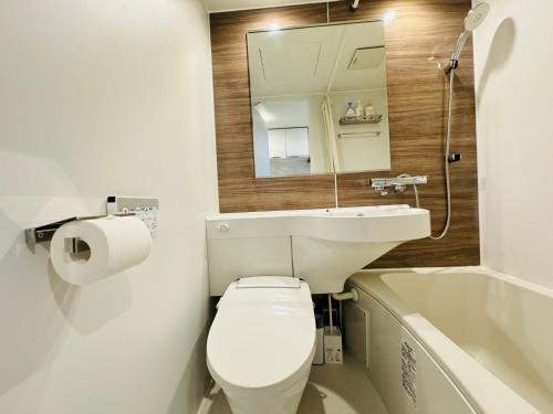 a bathroom with a toilet and a sink and a tub at Shinjuku Kabukichō-4F in Tokyo