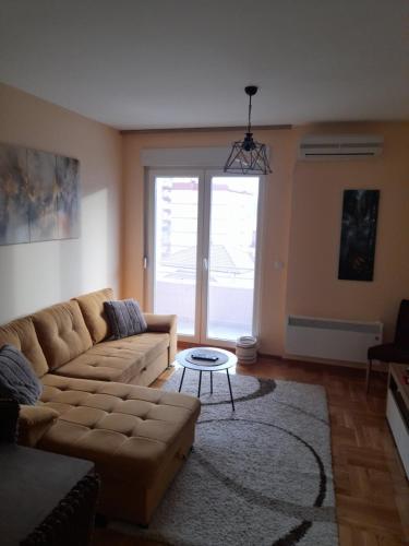 a living room with a couch and a table at Apartman Nomino in Zvornik
