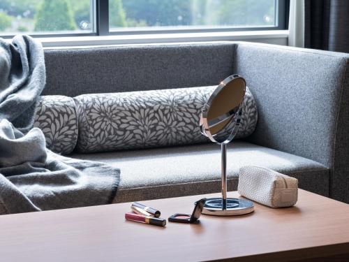 a mirror on a table in front of a couch at Mitsui Garden Hotel Kashiwa-no-ha Park Side - Chiba in Kashiwa
