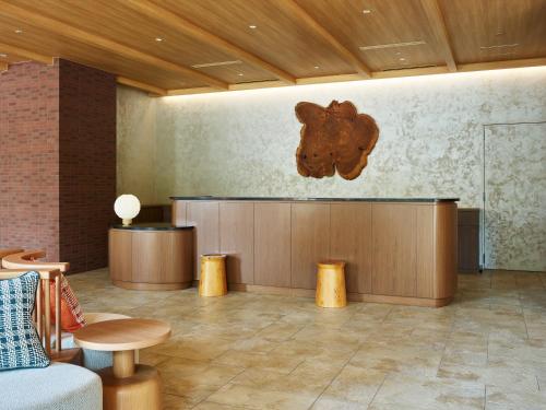 a lobby with a bear sculpture on the wall at Mitsui Garden Hotel Kashiwa-no-ha Park Side - Chiba in Kashiwa