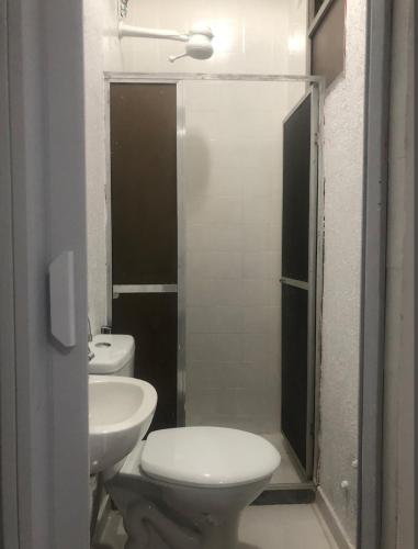 a bathroom with a toilet and a sink at Suíte 304 - Pousada no Centro do Rio in Rio de Janeiro