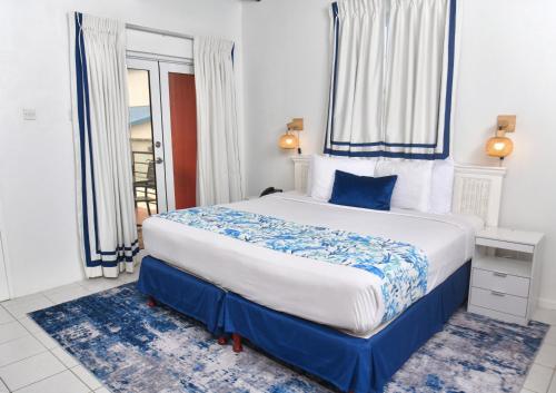 a bedroom with a large bed and a window at Melbourne Inn in Christ Church