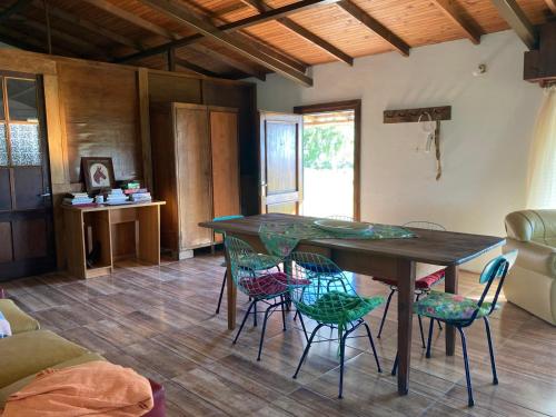 a dining room with a table and chairs at Casa de campo in Termas de Guaviyu