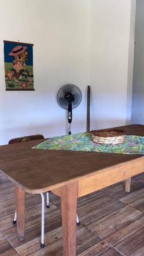a wooden table with a fan on top of it at Casa de campo in Termas de Guaviyu