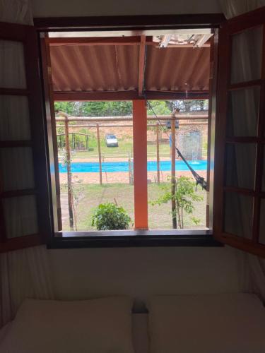 a window in a room with a view of a playground at Pousada Chácara Sonho in Hortolândia