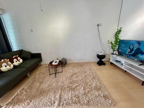 a living room with a couch and a tv at Home10perwira#6pax#netflix#simpangampat#neariconicpoint in Simpang Ampat