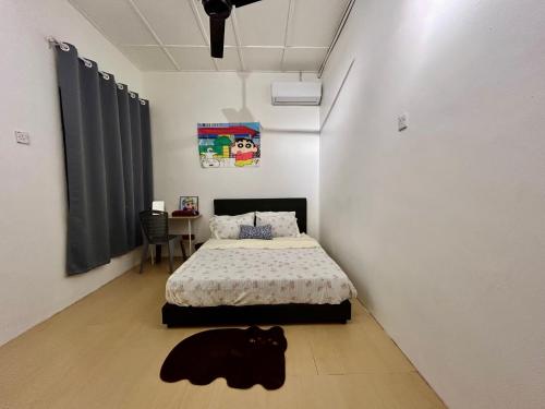 a black cat laying on the floor in a bedroom at Home10perwira#6pax#netflix#simpangampat#neariconicpoint in Simpang Ampat