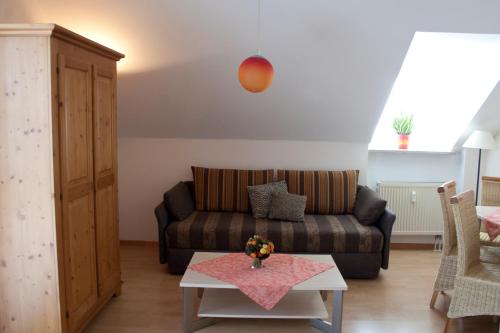 a living room with a couch and a table at Hotel Linner in Erding