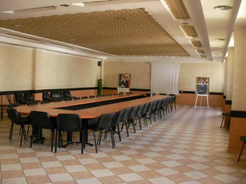 a conference room with a long table and chairs at Hotel Safa in Sidi Ifni