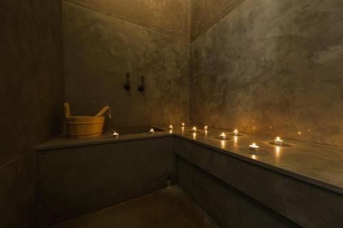 a bathroom with candles on a ledge with a tub at Villa AZUR - Wifi, Piscine chauffée, Sans vis-à-vis in Marrakech