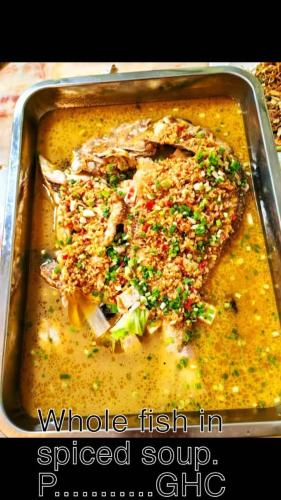 a pan of food with a piece of food in it at Hongyuan Premier hotel in Accra