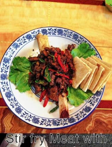 a blue and white plate of food on a table at Hongyuan Premier hotel in Accra
