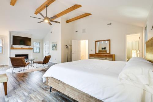 a bedroom with a large white bed and a fireplace at Family Getaway Less Than 2 Mi to Massanutten Ski Lodge! in McGaheysville