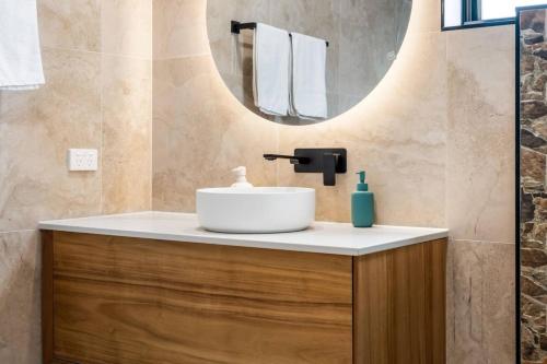 a bathroom with a sink and a mirror at Austins Ferry Haven Modern Waterfront Retreat in Austins Ferry