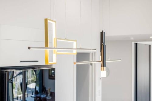 a bathroom with three lights hanging from the wall at Austins Ferry Haven Modern Waterfront Retreat in Austins Ferry