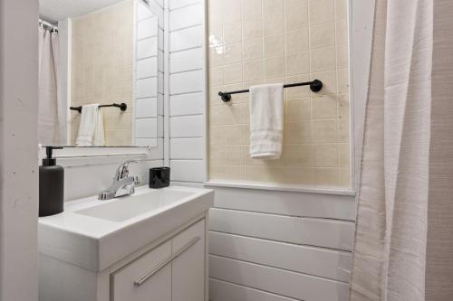 a white bathroom with a sink and a mirror at Quaint Lakeview Getaway Trails & Town at Your Doorstep in Walker
